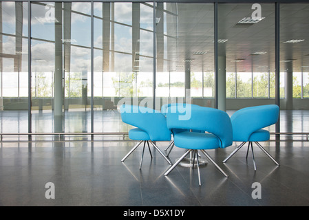 Chairs and table in office lobby area Stock Photo
