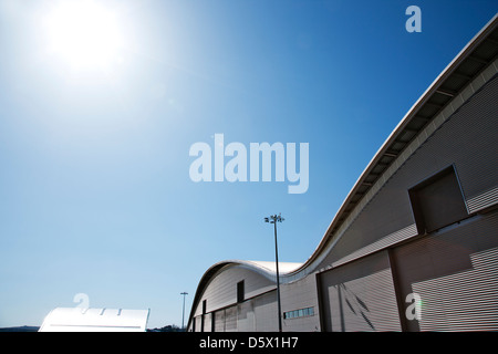 Curved roof of warehouse and blue sky Stock Photo