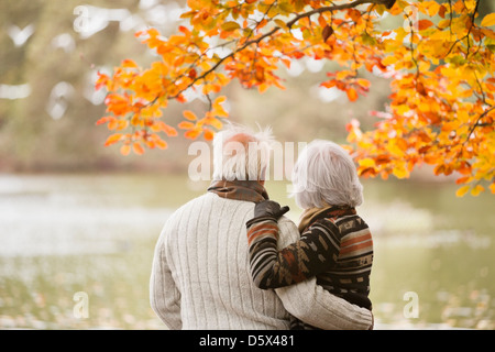 Older couple standing in park Stock Photo