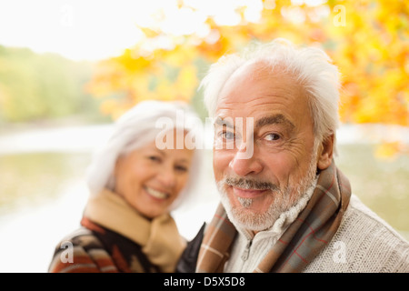 Older couple standing in park Stock Photo