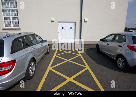 fire exit keep clear emergency doors and car park markings in a public access building moira county down northern ireland uk Stock Photo