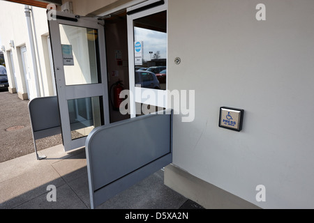 press to open disabled automatic door access to a public building northern ireland uk Stock Photo