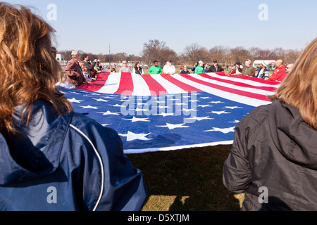 Group of people holding large American flag - Washington, DC USA Stock Photo