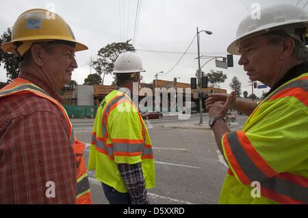 March 27, 2013 - Los Angeles, California, U.S - An inspector talks to the workers at the site of the construction of the Metro Expo Line extension at National and Palms boulevards in Los Angeles. Exposition Transit Corridor, Phase 2 will extend westward to Santa Monica from the Metro Expo Line Culver City Station and run along the old Pacific Electric Exposition right-of-way to 4th St. and Colorado Av. in downtown Santa Monica. The 6.6 mile second phase will connect Santa Monica by rail to Downtown LA, Pasadena, San Fernando Valley, South Bay, Long Beach and dozens of points in between. With s Stock Photo