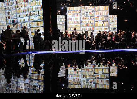 Visitors stand in front of the big screens inside Guest of Honor New Zealand's pavilion on the Book Fair fair grounds in Frankfurt am Main, Germany, 13 October 2012. One day before it closes, the world's largest book fair opened its doors for the general public. Photo: Arne Dedert Stock Photo
