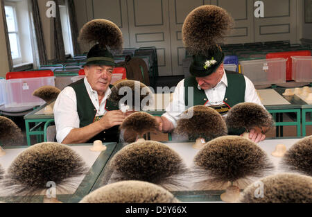 Member of the jury Hias Koch (R) and Herbert Eder examine parts of a hat called chamios beard during the 26th Gamsbart Olympics (lit. chamois beard olympics) in Mittenwald, Germany, 14 October 2012. Up to 100 participants from different Apline areas competed at the event. Photo: Frank Leonhardt Stock Photo