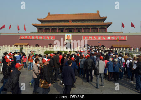 Many tourists stand in front of the main entrance to the Forbidden City, which carries a portrait of Mao Zedong, in Beijing, China, 12 October 2012. Photo: Rainer Jensen Stock Photo