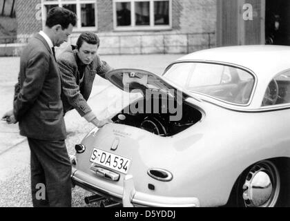 HANDOUT - A handout picture dated 1958 shows Ferry Porsche (L) and his oldest son Ferdinand Alexander standing at the rear of a Porsche Type 356 A Carrera Hardtop. The honorary chairman of the supervisory board of Porsche, Professor Ferdinand Alexander Porsche, is dead. The creator of the legendary Porsche 911 died at the age of 76 as the car manufacturer announced on 05 April 2012 Stock Photo
