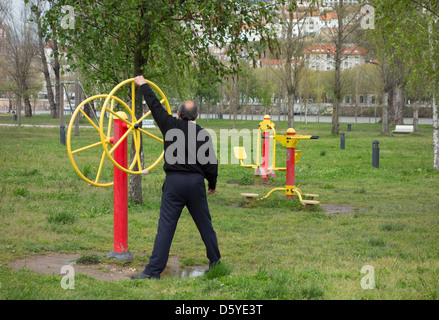 Person working out in an outdoors public fitness park Stock Photo