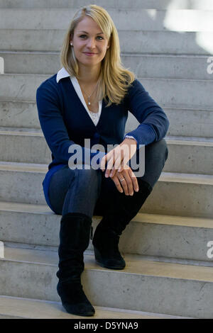 Former biathlete Magdalena Neuner sits on a stair during the official outfitting of the German Ski Association (DSV) in Herzogenaurach, Germany, 31 October 2012. Photo: Daniel Karmann Stock Photo