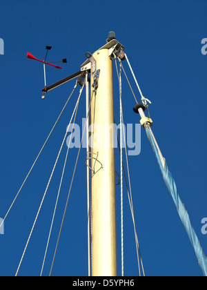The top of a sailing ships mast against a blue sky Stock Photo