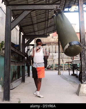 A pupil of the Cuban state boxing school 'Gimnasio de Boxeo Rafael Trejo' practices in Havanna, Cuba, 28 March 2012. Photo: Marco Hadem Stock Photo