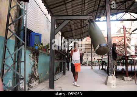 A pupil of the Cuban state boxing school 'Gimnasio de Boxeo Rafael Trejo' practices in Havanna, Cuba, 28 March 2012. Photo: Marco Hadem Stock Photo