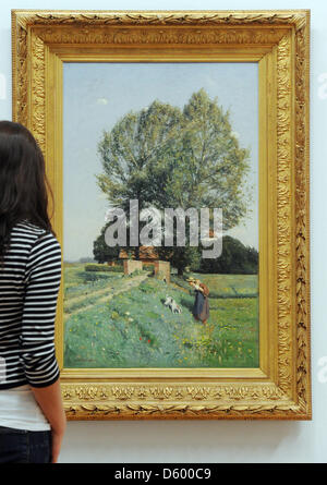 A visitor views the painting 'Joys of Summer in front of House Kump' from 1889 by Otto Modersohn at the Municipal Gallery in Karlsruhe, Germany, 07 November 2012. The painting is part of the exhibition 'Nature and Poetry around 1900. Otto Modersohn, Paula Modersohn-Becker and Worpswede' which runs from 11 November 2012 till 17 February 2013. Photo: ULI DECK Stock Photo