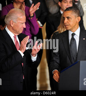 United States Vice President Joe Biden applauds as U.S. President Barack Obama completes his statement in the East Room of the White House in Washington, D.C. about the action he believes is needed to avoid the 'fiscal cliff' of automatic tax increases and spending cuts due to take effect in January, 2013..Credit: Ron Sachs / CNP Stock Photo