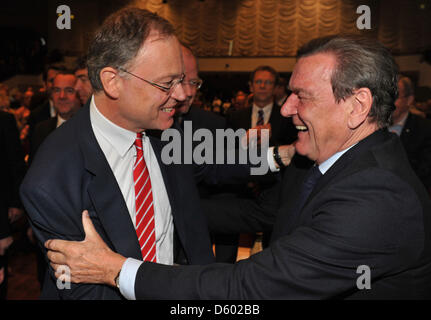 The SPD top candidate for the upcoming state parliament election in Lower Saxony, Stephan Weil (l), greets former Gemany chancellor Gerhard Schroeder (r) during the state party meeting of the Lower Saxonian Social Democrats in Wolfsburg, Germany, 10 November 2012. Two months before the elections, the party will agree on their electoral program. Photo: JOCHEN LUEBKE Stock Photo