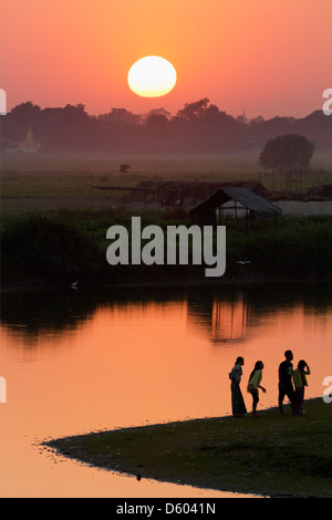 Spectacular sunset over the paddy fields and pagodas, viewed from U Bein Teak Bridge, Myanmar 5 Stock Photo