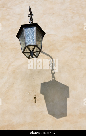 Old street lamp on the wall Stock Photo