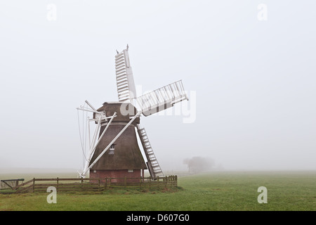 wooden windmill in fog Stock Photo