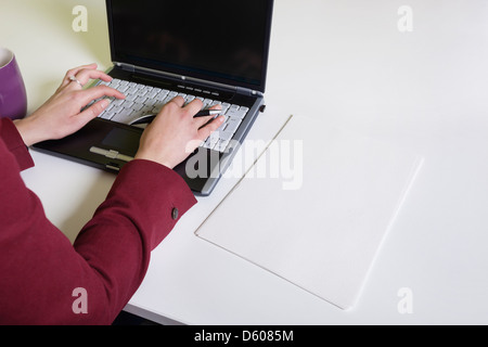 Cropped image of businesswoman's hands using laptop t desk Stock Photo