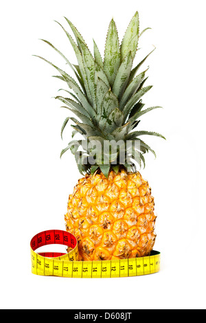 Pineapple and yellow measuring tape isolated on white Stock Photo