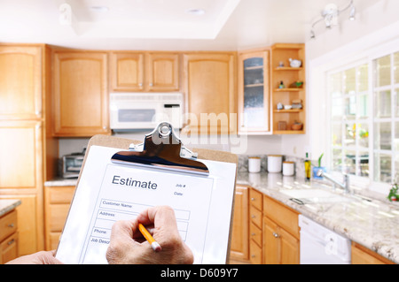 Closeup of a contractors clipboard as he write up an estimate for a kitchen remodel. Stock Photo