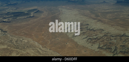 Aerial valley floor view, to Oljato Mesa, braided stream channel passing heavily eroded white rock slope, Piute Farms Wash, Utah Stock Photo