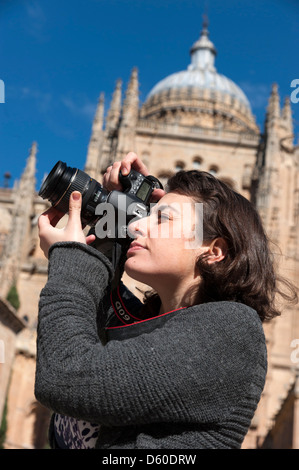 Tourist taking photos with Canon digital camera outside Salamanca New Cathedral, Spain Stock Photo