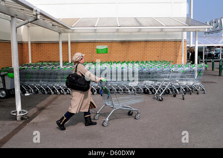A women pushing a shopping trolley outside ASDA supermarket, London, UK Stock Photo