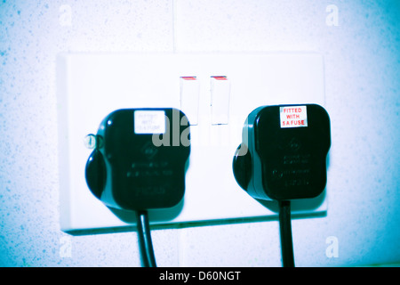 Plugs in double wall socket Stock Photo