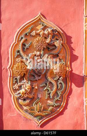 Carved flowers on the red wall of Forbidden City Stock Photo
