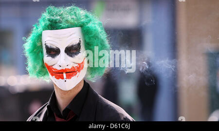 A member of the action group 'Anonymous' wears a masque as he stands during a protest action in front of the Church of Scientology building in the city centre of Hamburg, Germany, 14 April 2012. The members of 'Anonymous' have been calling for attention to the perils posed by the Church of Scientology in their monthly protest actions. Photo: Malte Christians Stock Photo