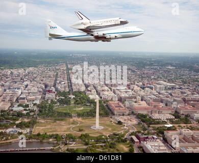 HANDOUT - Space shuttle Discovery, mounted atop a NASA 747 Shuttle Carrier Aircraft (SCA), flies over the Washington skyline as seen from a NASA T-38 aircraft, Tuesday, April 17, 2012. Discovery, the first orbiter retired from NASA s shuttle fleet, completed 39 missions, spent 365 days in space, orbited the Earth 5,830 times, and traveled 148,221,675 miles. NASA will transfer Disco Stock Photo