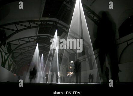 Visitors walk through vertical light sculptures by British artist AAnthony McCall at Hamburger Bahnhof - Museum for the Present in Berlin, Germany, 19 April 2012. The exhibition is titled 'Five Minutes of Pure Sculpture' is the most extensive McCall exhibition up to now. The exhibition runs from 20 April 2012 till 12 August 2012. Photo: STEPHANIE PILICK Stock Photo