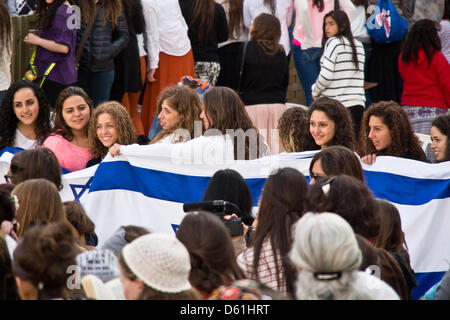 Jerusalem, Israel. 11th April 2013. Young female worshipers wrap themselves in Israeli flags in the women's section at the Western Wall. Jerusalem, Israel. 11-April-2013.  Five women detained at Western Wall for donning prayer shawls and phylacteries in defiance of Orthodox Jewish monopoly reserving these practices for men, a ruling Women of The Wall have been battling, demanding egalitarian practice of Judaism.` Credit: Nir Alon / Alamy Live News Stock Photo