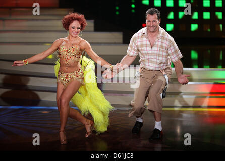 Former German discus thrower Lars Riedel and dancer Marta Arndt perform on stage during RTL television dance show 'Let's Dance' in Cologne, Germany, 25 April 2012. Six stars ventured into the fifth episode of season five with their dance partners on the dance floor. Photo: Rolf Vennenbernd Stock Photo