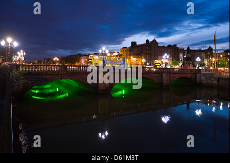 Horizontal upstream view of the O'Connell Bridge or Droichead Uí Chonaill crossing the River Liffey in Dublin at night. Stock Photo