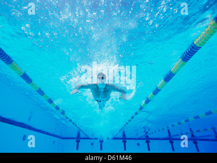 Underwater shot of male swimmer swimming in pool Stock Photo