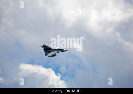 Horizontal view of a Royal Air Force Tornado F3 jet flying in a cloudy sky. Stock Photo