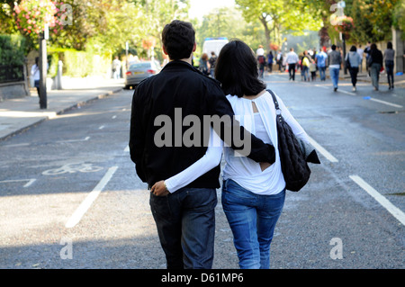 A couple walking with their arms around each other. Stock Photo