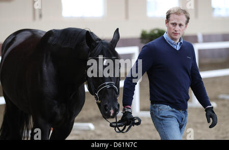 German dressage ride Matthias Rath leads his horse 'Totilas' to the veterinary examination during the Horse & Dreams equestrian event in Hagen Am Teutoburger Wald, Germany, 27 April 2012. Photo: FRISO GENTSCH Stock Photo