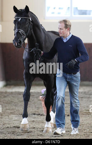 German dressage ride Matthias Rath leads his horse 'Totilas' to the veterinary examination during the Horse & Dreams equestrian event in Hagen Am Teutoburger Wald, Germany, 27 April 2012. Photo: FRISO GENTSCH Stock Photo