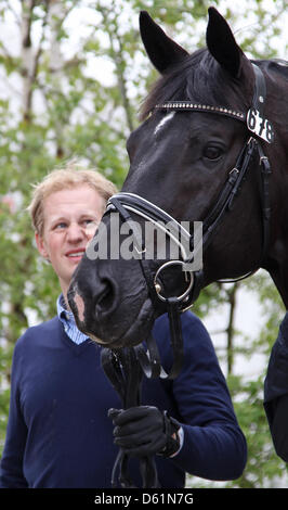 German dressage ride Matthias Rath leads his horse 'Totilas' to the veterinary examination during the Horse & Dreams equestrian event in Hagen Am Teutoburger Wald, Germany, 27 April 2012. Photo: FRISO GENTSCH Stock Photo