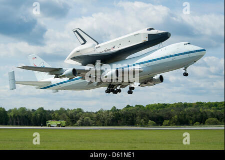 Space shuttle Enterprise, mounted atop a NASA 747 Shuttle Carrier Aircraft (SCA), is seen as it takes off for New York from Washington Dulles International Airport, Friday, April 27, 2012, in Sterling, Virginia. Enterprise was the first shuttle orbiter built for NASA performing test flights in the atmosphere and was incapable of spaceflight. Originally housed at the Smithsonian's S Stock Photo