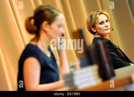 Actress Melanie von Sass (L) reads next to French singer Patricia Kaas smiles during the presentation of Kaas' autobiography Mademoiselle sings the Blues: My life' in Saarbruecken, Germany, 28 April 2012. Photo: Becker & Bredel Stock Photo