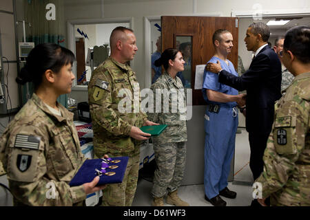 United States President Barack Obama (R) greets hospital personnel in the ICU at Bagram Air Field, Afghanistan, May 1, 2012. The President presented ten Purple Hearts, three in the ICU. Photo: Pete Souza - White House via CNP Stock Photo