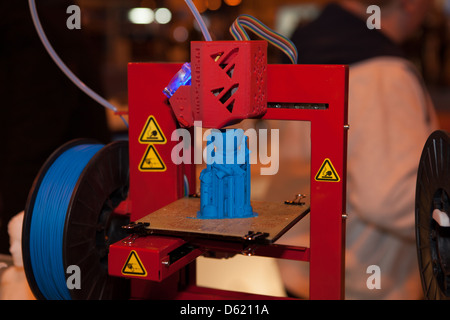 A 3D Printer in action on a trade stand at an exhibition. Stock Photo
