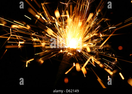 yellow sparkler holiday background on black