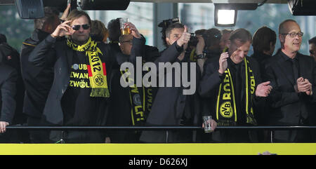 Borussia Dortmund's head coach Juergen Klopp (L-R), manager Michael Zorc and CEO Hans-Joachim Watzke attend the championship celebrations at the Wall in Dortmund, Germany, 13 May 2012. After the final with the most goals of the last 26 years Borussia Dortmund won the German DFB Cup by defeating Bayern Munich 5-2 on 12 May 2012. It is the first time in the club's 103 year history th Stock Photo