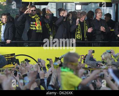Borussia Dortmund's head coach Juergen Klopp (front, L-R), manager Michael Zorc and CEO Hans-Joachim Watzke attend the championship celebrations at the Wall in Dortmund, Germany, 13 May 2012. After the final with the most goals of the last 26 years Borussia Dortmund won the German DFB Cup by defeating Bayern Munich 5-2 on 12 May 2012. It is the first time in the club's 103 year his Stock Photo
